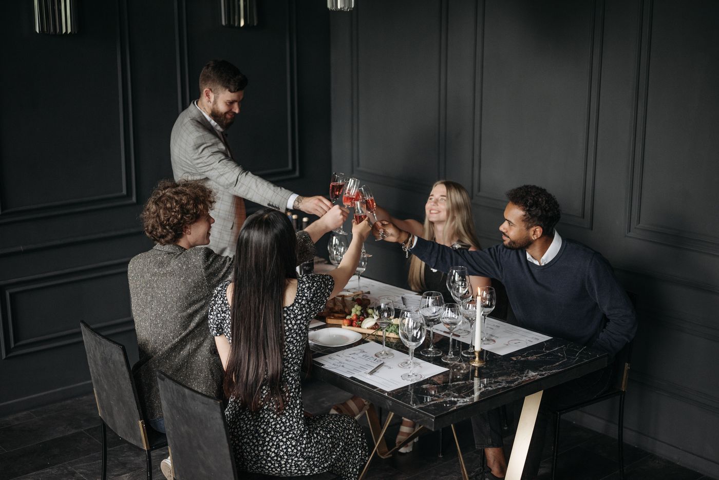 Avenue Society members toasting at an elegant private dinner